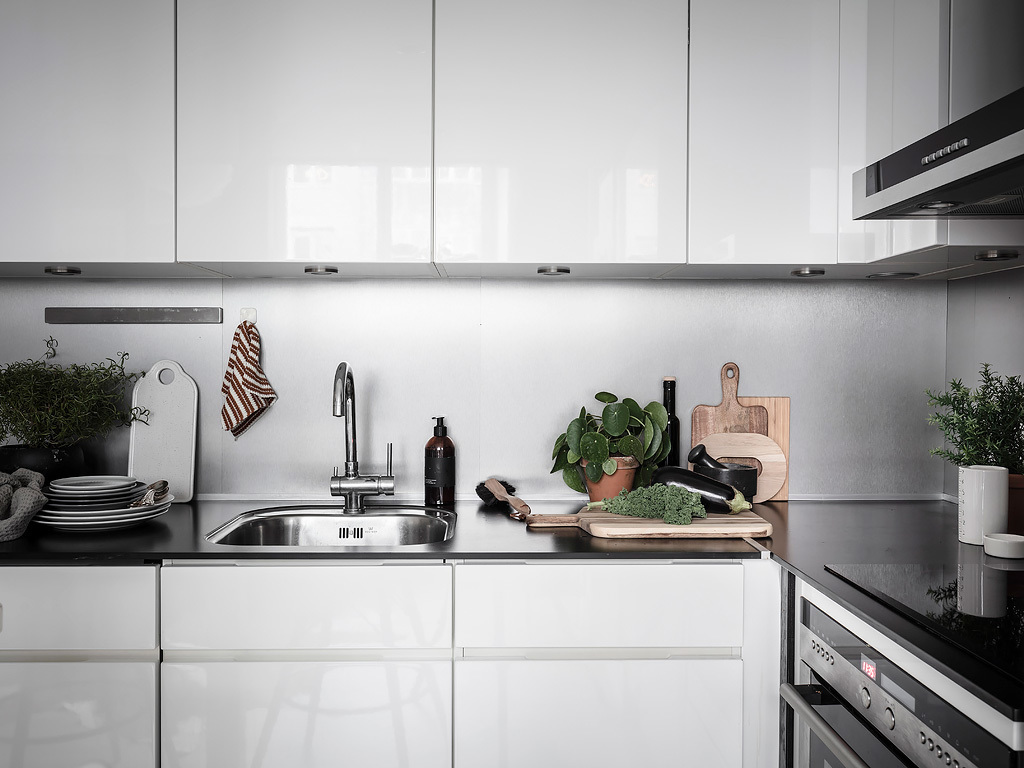 Biała nowoczesna zabudowa kuchenna w tylu skandynawskim